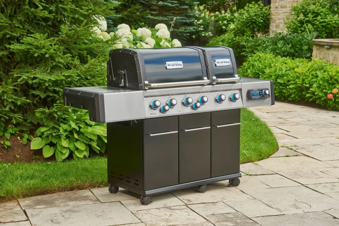 Broil King Regal 690 Pro IR six-burner stainless steel gas grill on black cart with infrared rotisserie, side shelves and storage — outdoor patio barbecue
