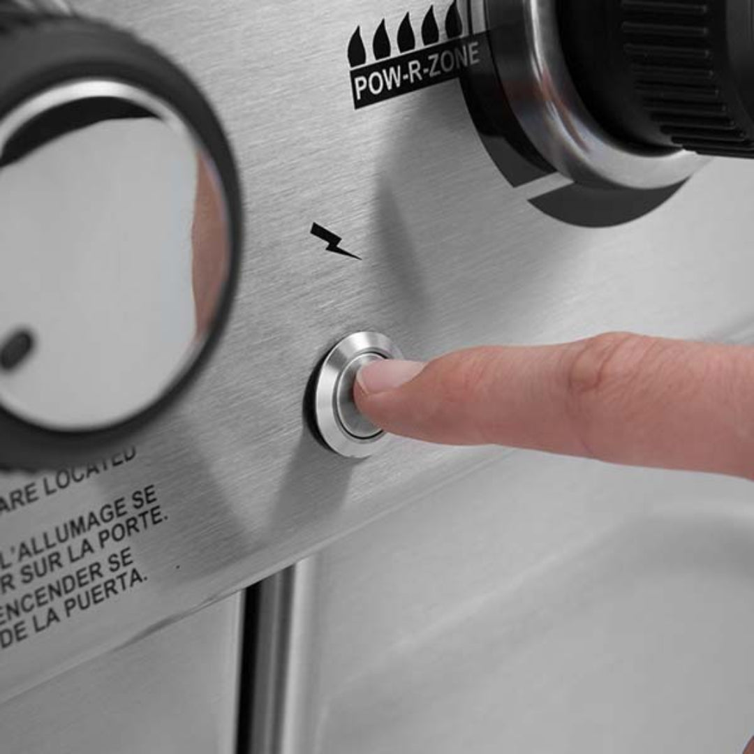 Ignition system, Broil King, Baron Series, close-up of push-button igniter being pressed on stainless control panel
