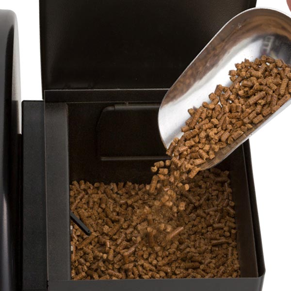 Pellet Hopper, Broil King, Regal Pellet Series, hardwood pellets being poured into side hopper for fuel loading