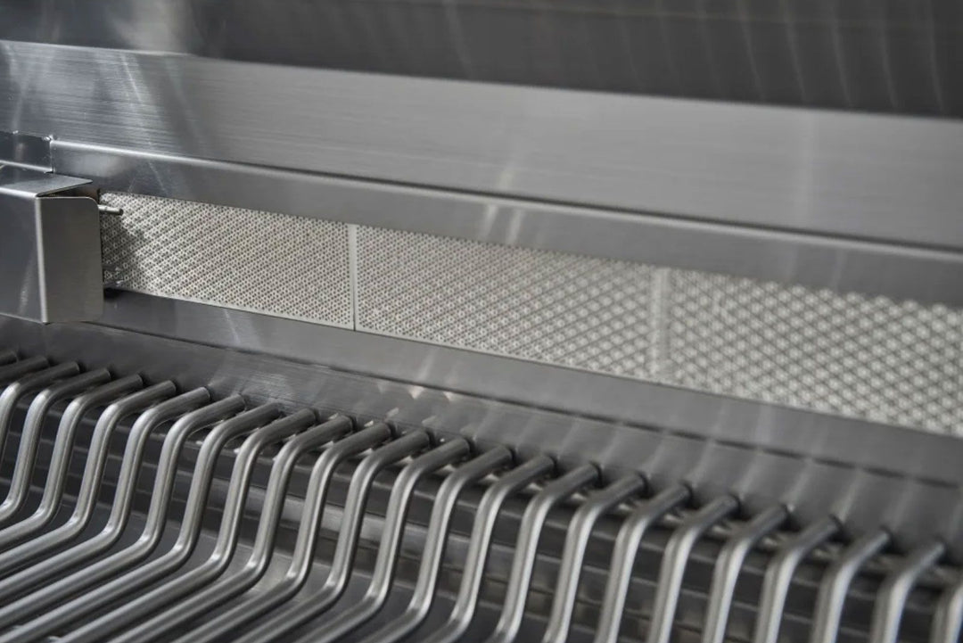 Broilmaster B-Series BSB324N 32-inch 4-burner stainless natural gas grill interior close-up showing stainless cooking grates and perforated heat shield (flame tamer)