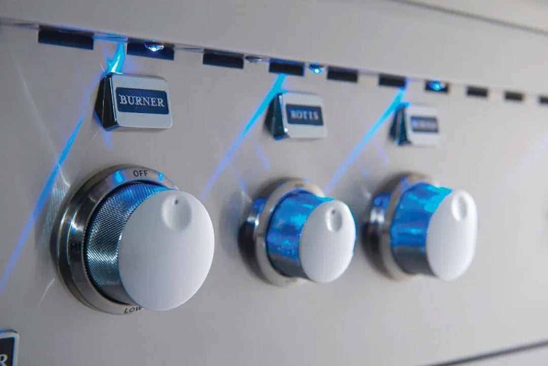 Broilmaster B-Series 40 BSB405P 40-inch 5-burner stainless propane gas grill control panel close-up with chrome white knobs and blue LED backlighting labeled BURNER