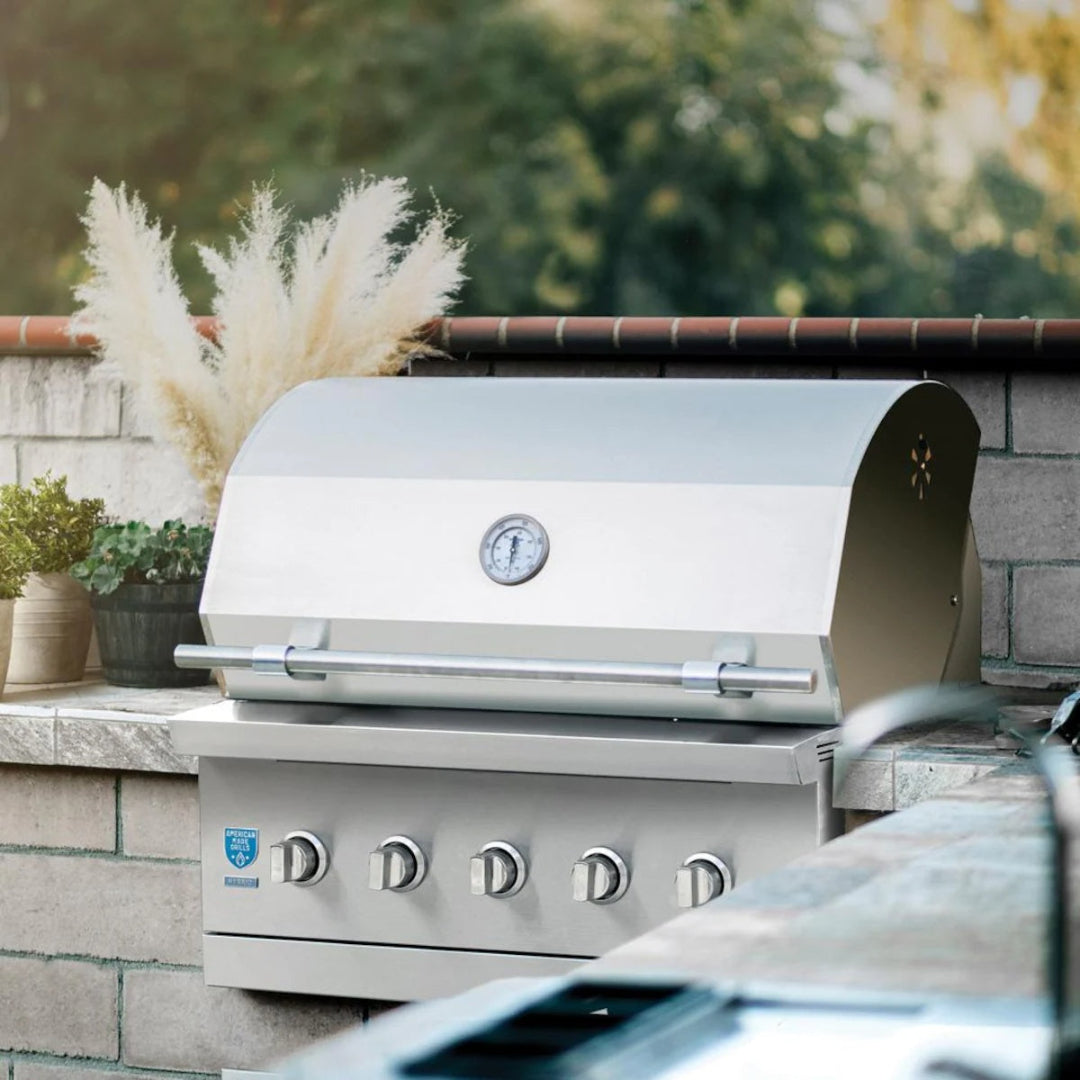 Built-in grill, American Made Grills, Encore 36-inch propane model installed in stone outdoor kitchen with closed hood