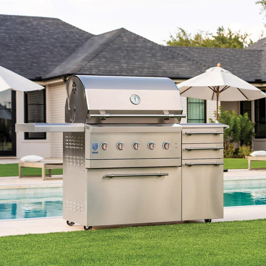 American Made Grills Encore 36-inch freestanding propane grill outdoors near pool with closed hood