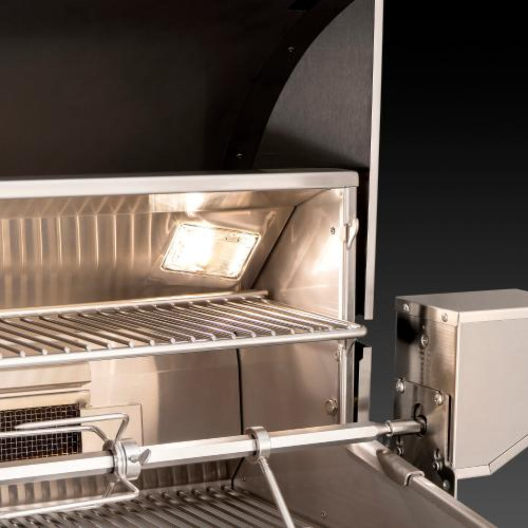 Fire Magic Echelon built-in stainless steel gas grill interior close-up with halogen light, rotisserie spit and stainless cooking grates