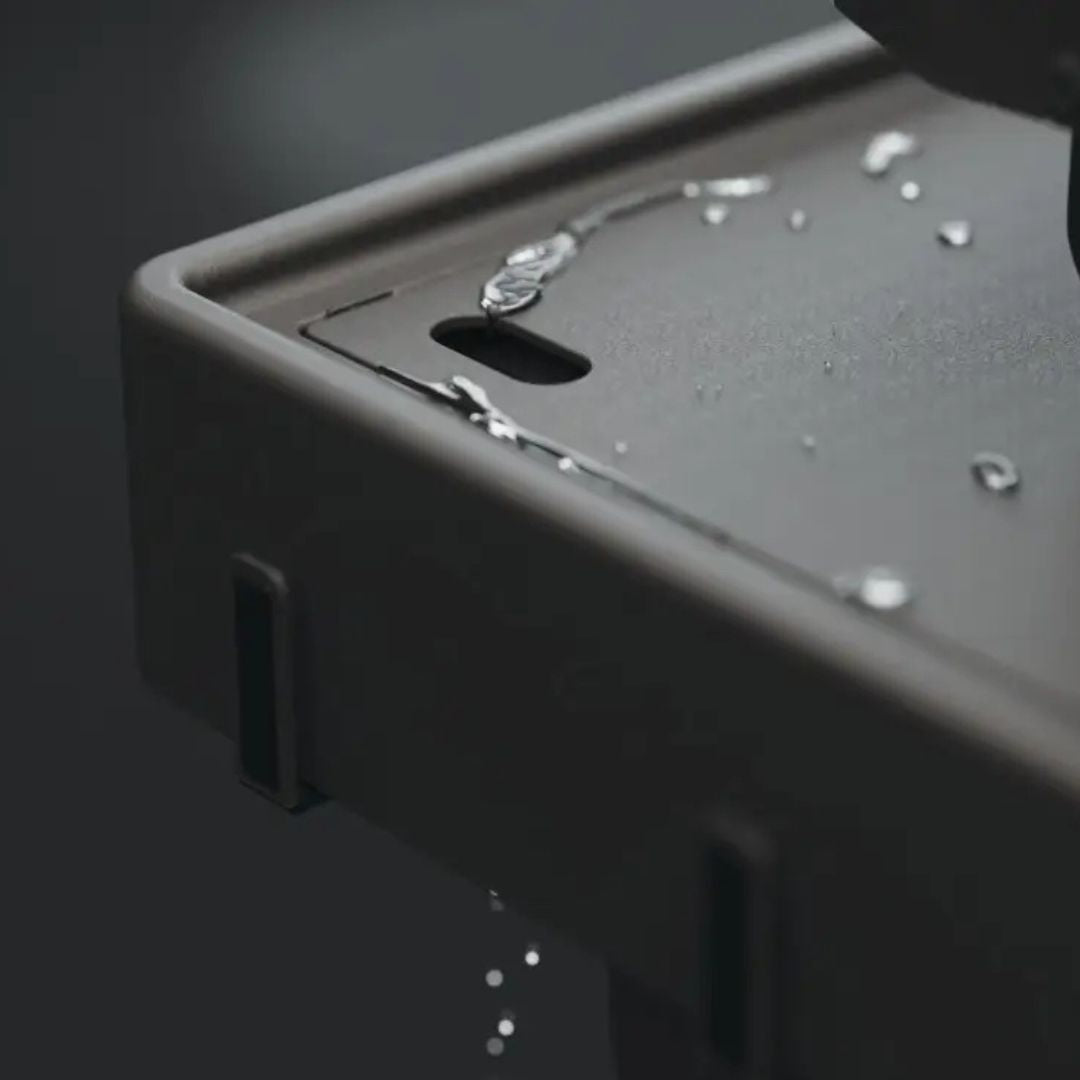 HALO Countertop Cart HO-1006-XNA close-up of black powder-coated countertop with drainage hole and water droplets