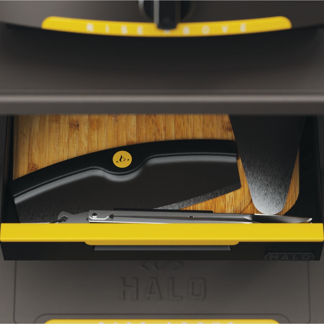 HALO Countertop Cart HO-1006-XNA open drop-down drawer with bamboo cutting board, black accessory caddy with yellow logo, metal tongs and pizza peel blade, yellow-accented drawer handle