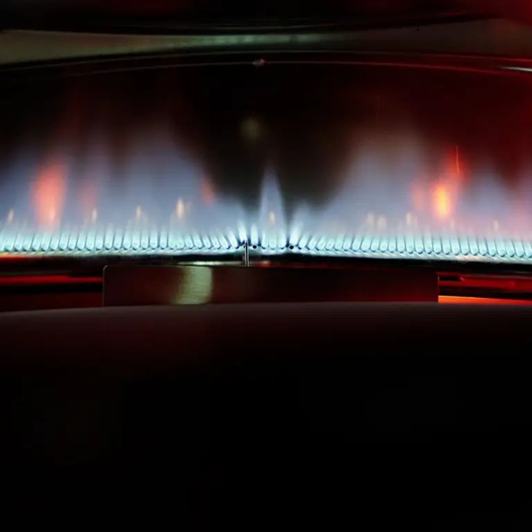 HALO Versa 16 outdoor gas pizza oven close-up of blue burner flames across oven interior