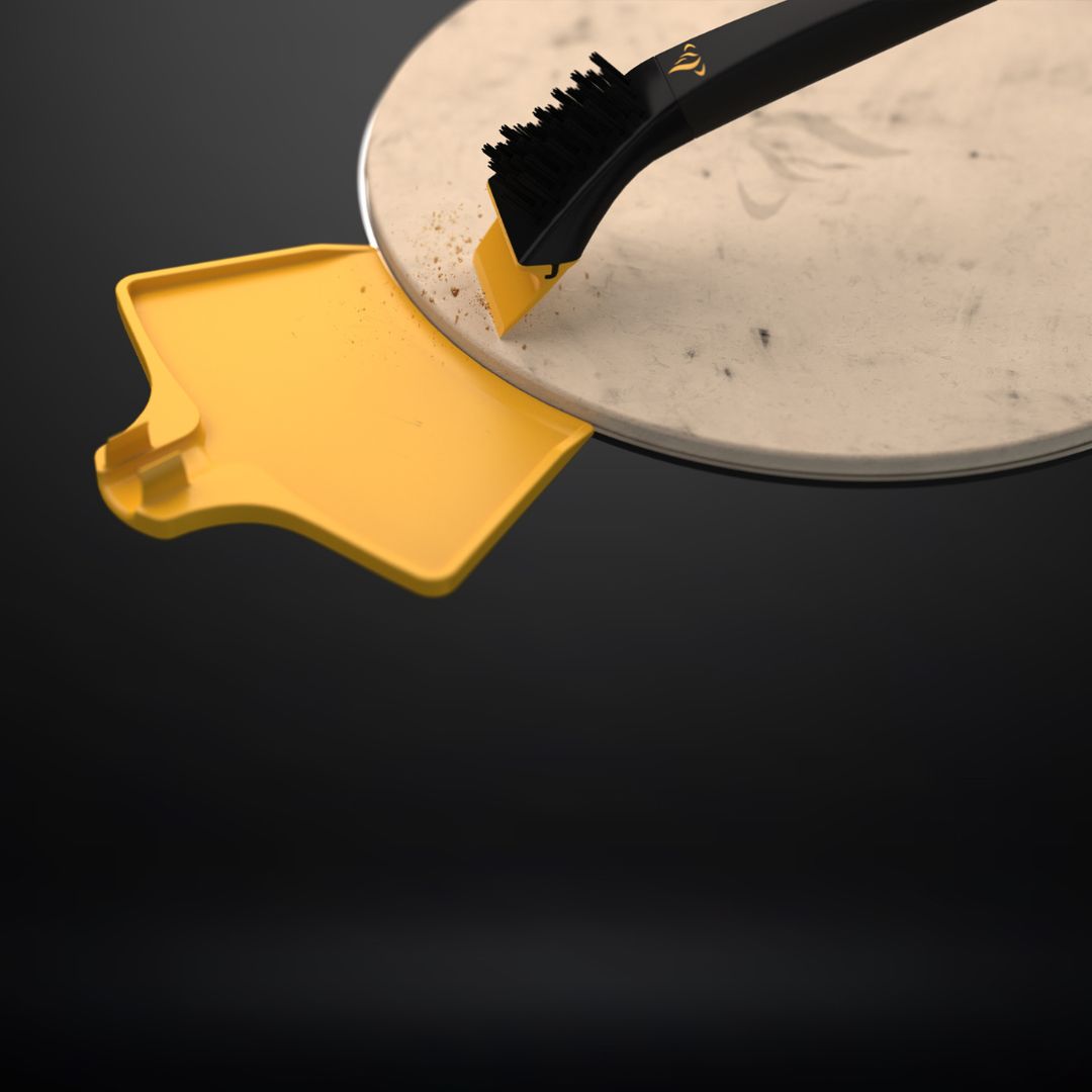 HALO Versa 16 pizza stone cleaning kit (HZ-3023) – black nylon-bristle brush with yellow scraper sweeping crumbs into a yellow ash pan on a cordierite pizza stone
