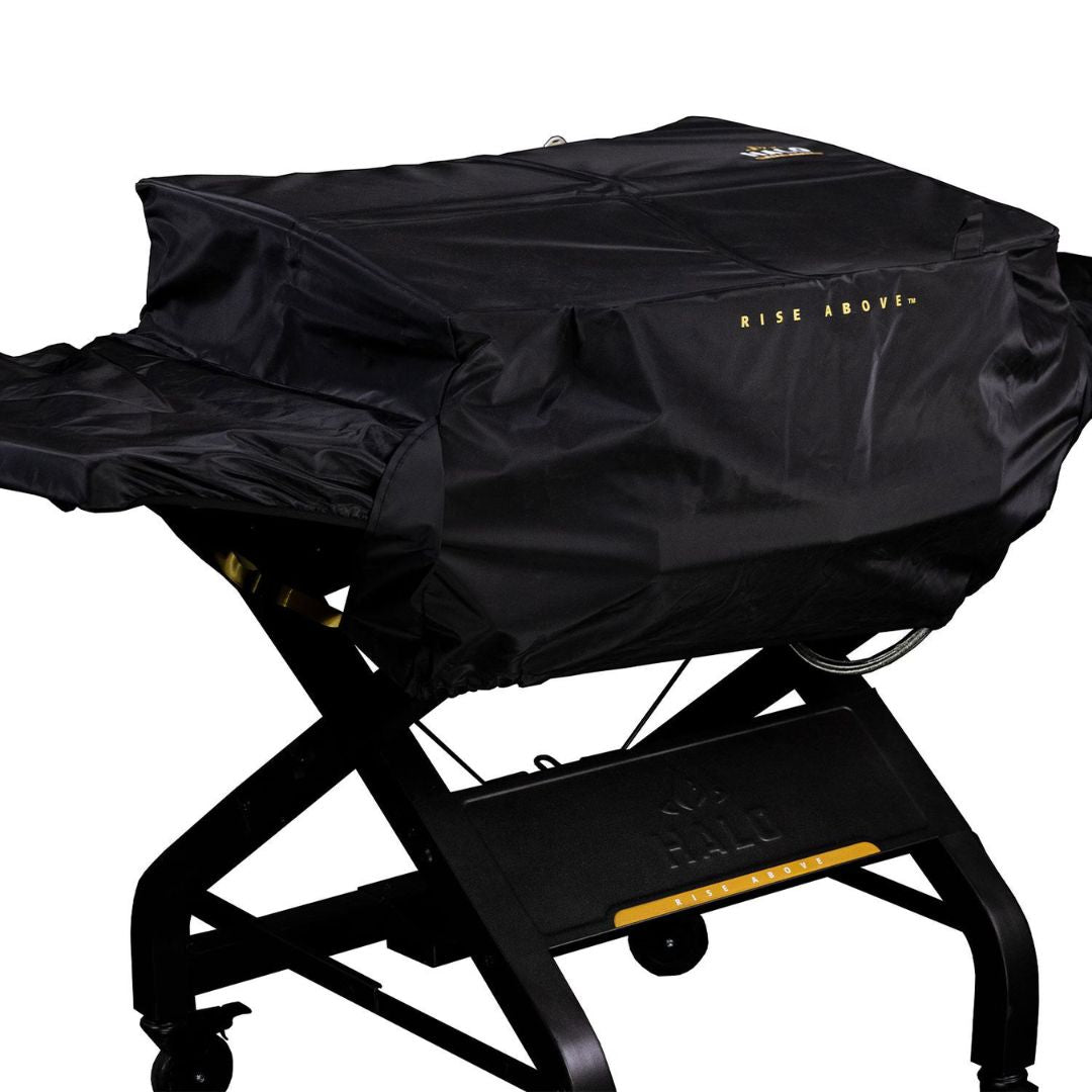 HALO Elite HZ-5002 black weather-resistant custom-fit griddle cover with "RISE ABOVE" logo fitted over HALO griddle on wheeled cart