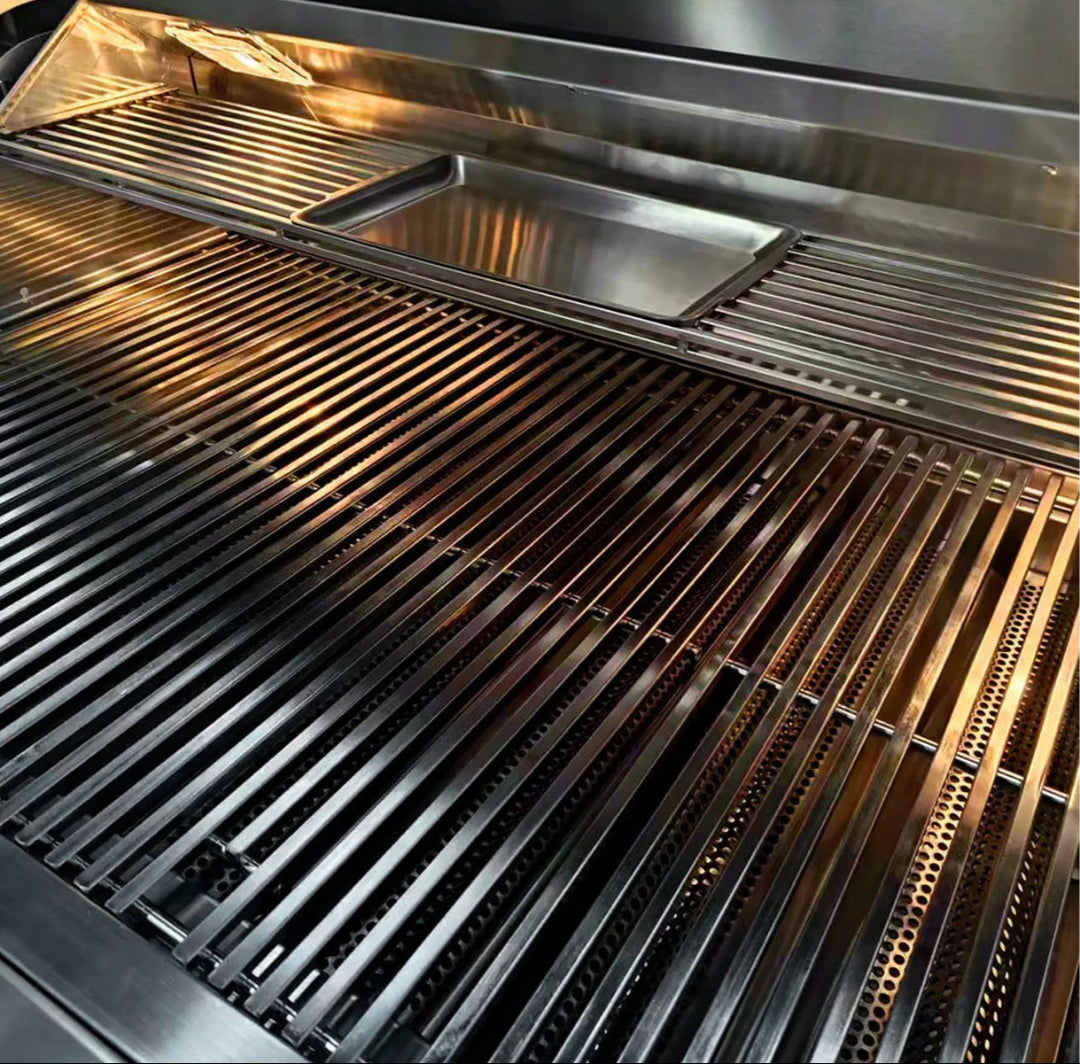TrueFlame TF32 32-inch 4-burner built-in propane gas grill interior close-up showing stainless steel cooking grates, upper warming rack and removable drip tray