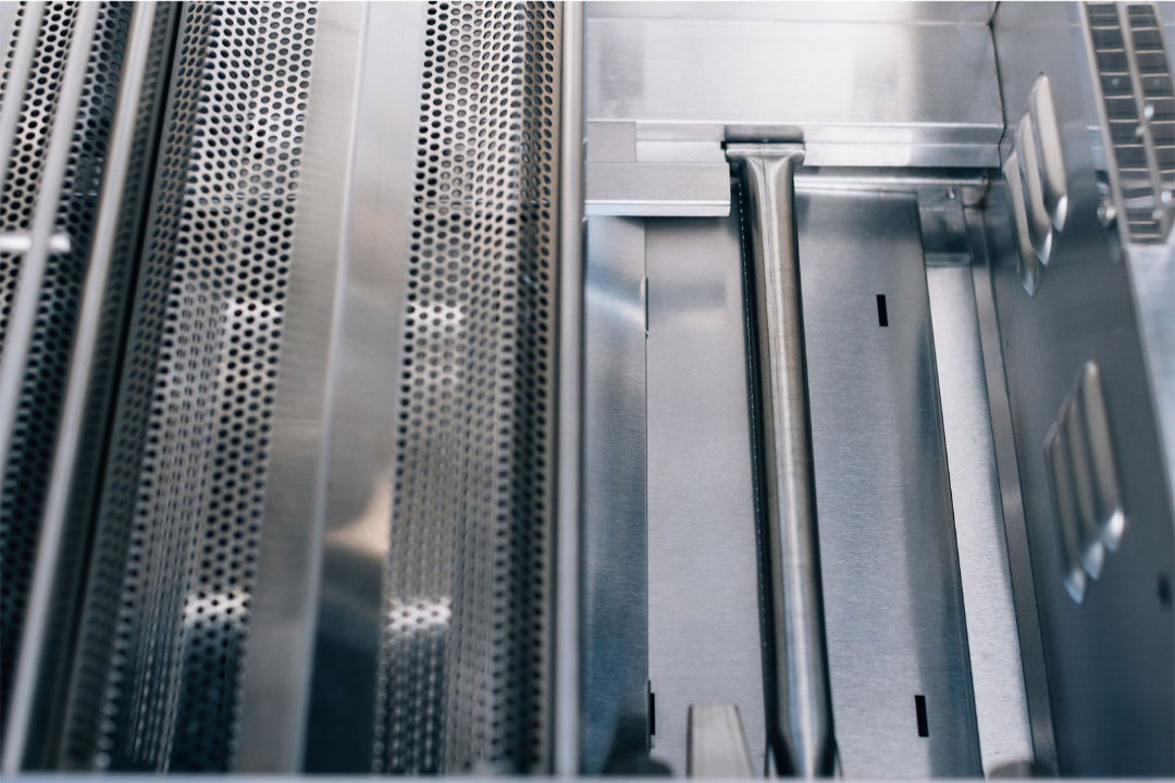 True Flame TFE25-NG built-in natural gas grill interior close-up showing stainless steel burner tube and perforated flavorizer bars