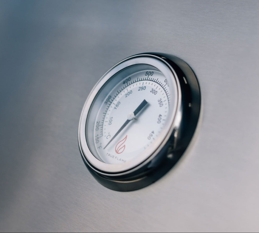 Close-up of stainless steel lid temperature gauge with TrueFlame logo on TFE Series 32 (TFE32-NG) 4-burner built-in natural gas grill