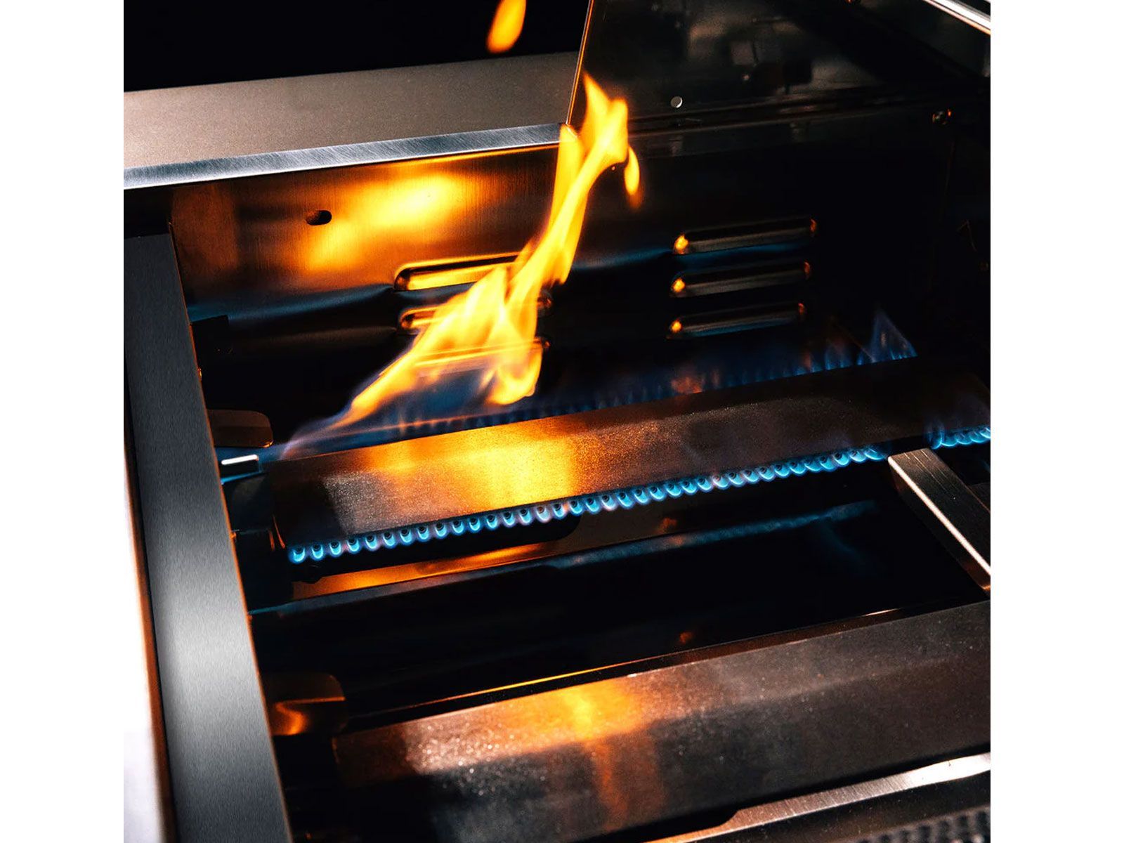 TrueFlame TF25-LP 25-inch TF Series 3-burner built-in propane gas grill interior close-up showing blue burner flames and stainless steel heat tent/sear plate