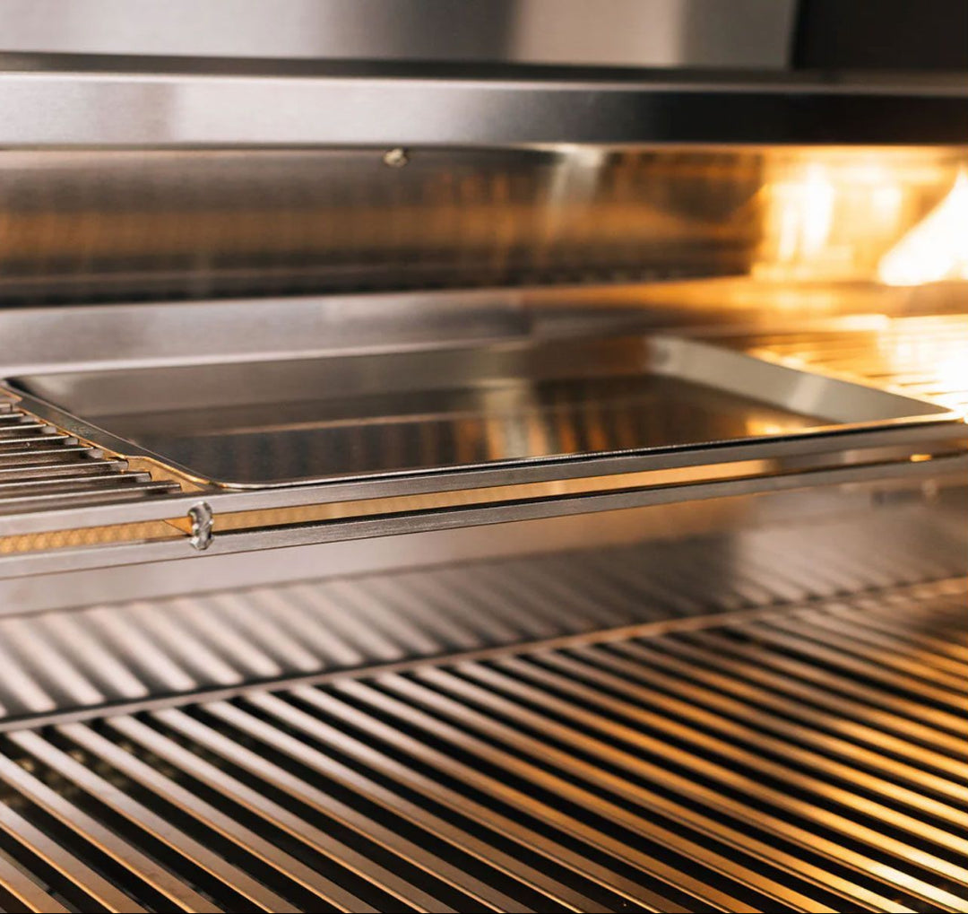 TrueFlame TF25-NG4 25-inch TF Series 3-burner built-in natural gas grill interior close-up showing stainless steel cooking grates, removable drip tray and warming rack