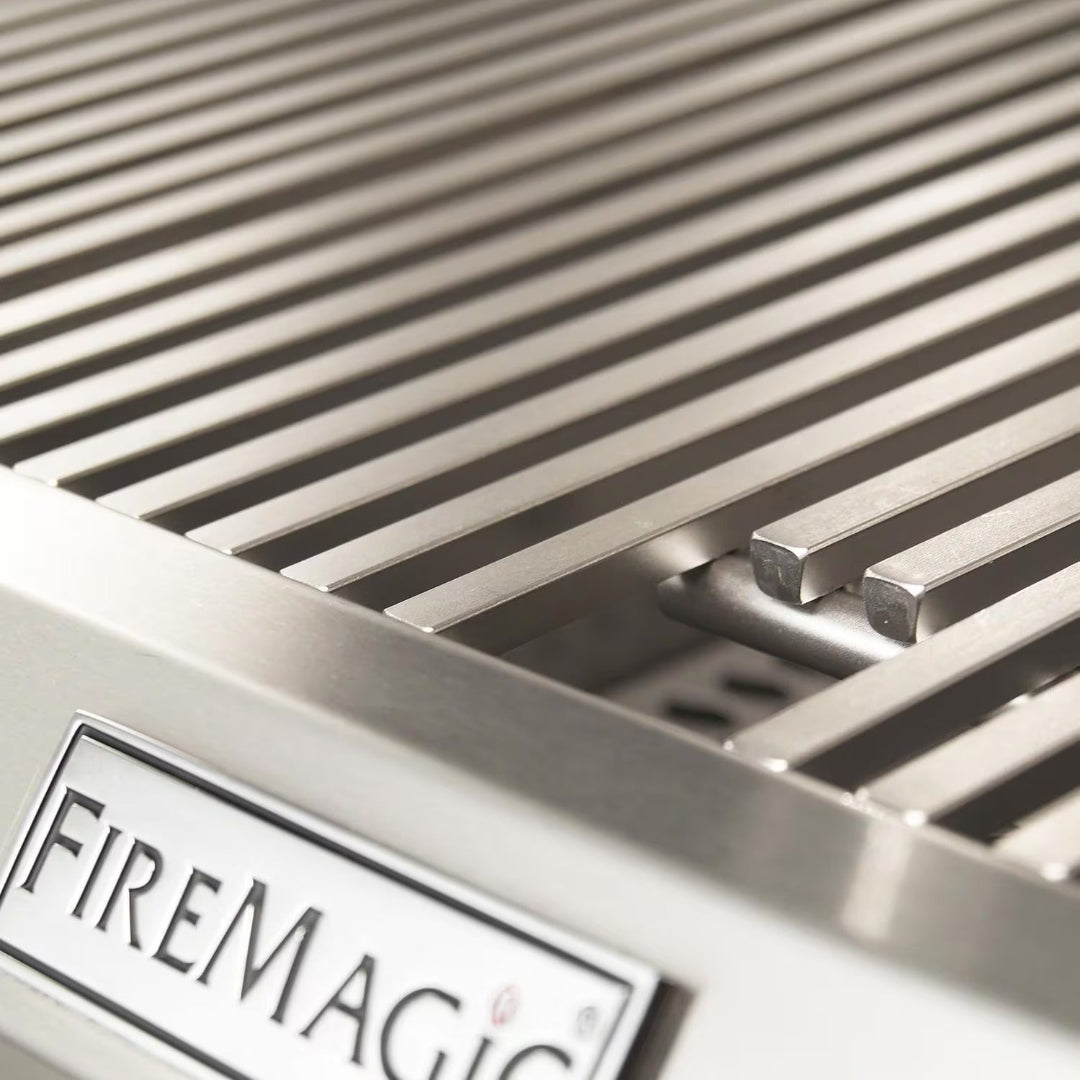 FireMagic Aurora Series stainless steel cooking grates close-up with FireMagic badge for built-in outdoor gas grill
