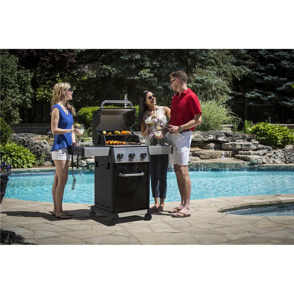 Outdoor grill, Broil King, Baron Series, 3-burner gas grill in use at poolside with people grilling and socializing