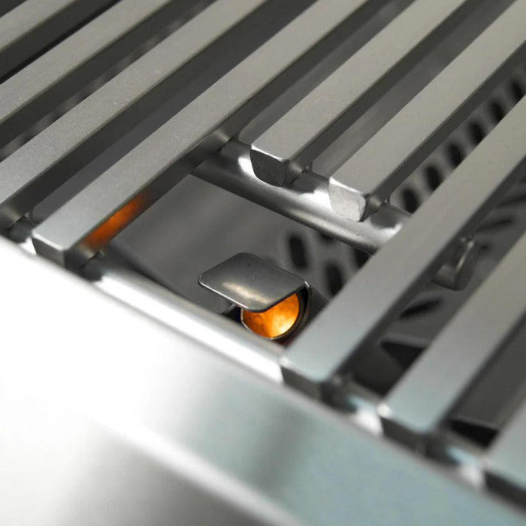 Fire Magic built-in gas grill stainless steel close-up of cooking grates and lit one infrared searing burner for outdoor kitchen