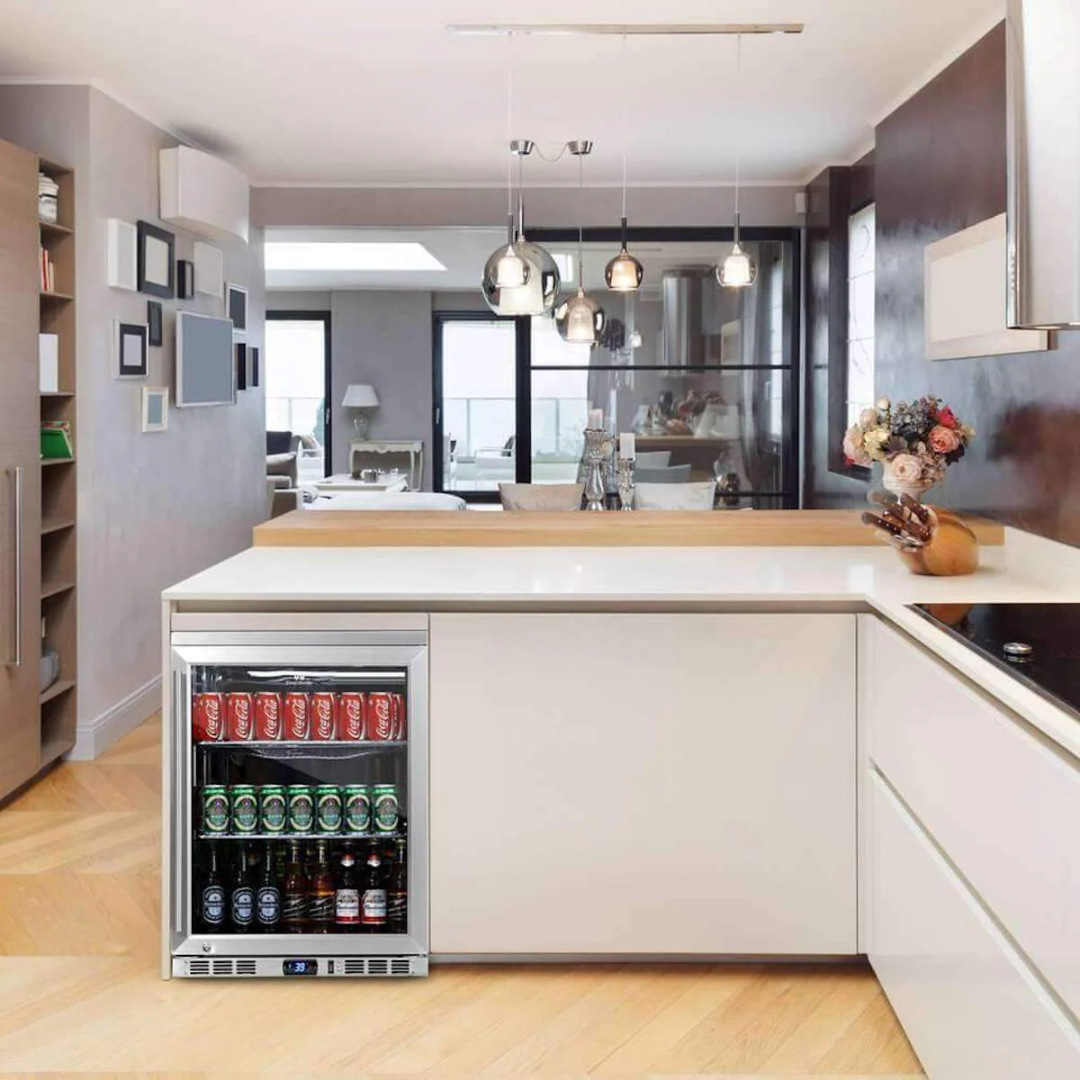 KBU55M built-in under-counter glass-door beer cooler in modern kitchen island, stainless steel trim compact beverage refrigerator with digital temperature display, stocked with cans and bottles