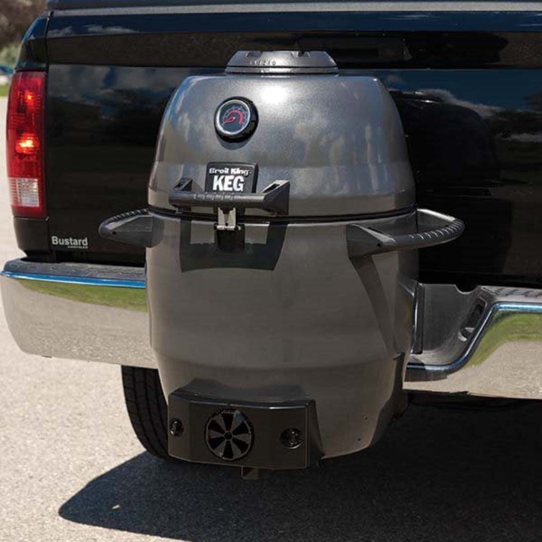 Kamado grill, Broil King, Keg series, mounted on truck hitch for tailgating, featuring side handles and front temperature gauge