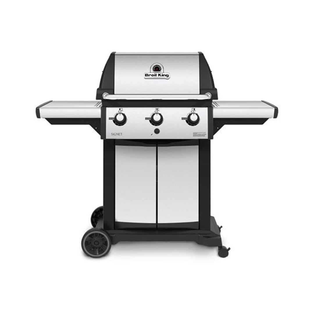 Gas grill, Broil King, Signet series, stainless steel front panel, three black knobs, double-door cabinet, front view on white